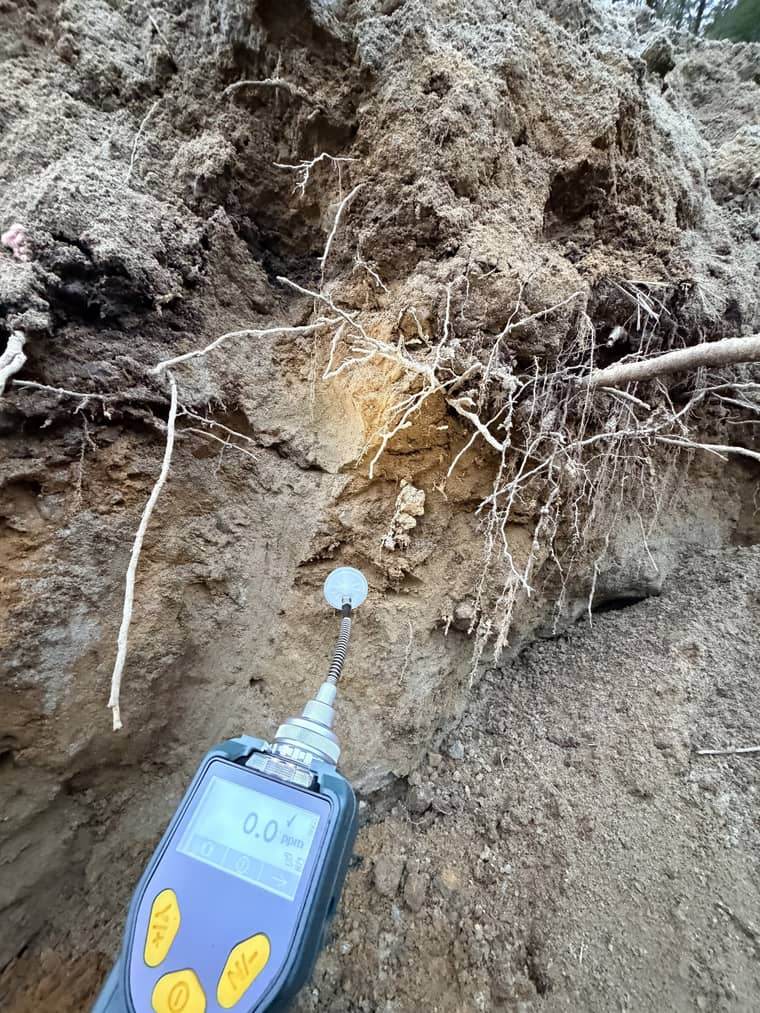 A photoionization detector screening soil in an excavation during sampling