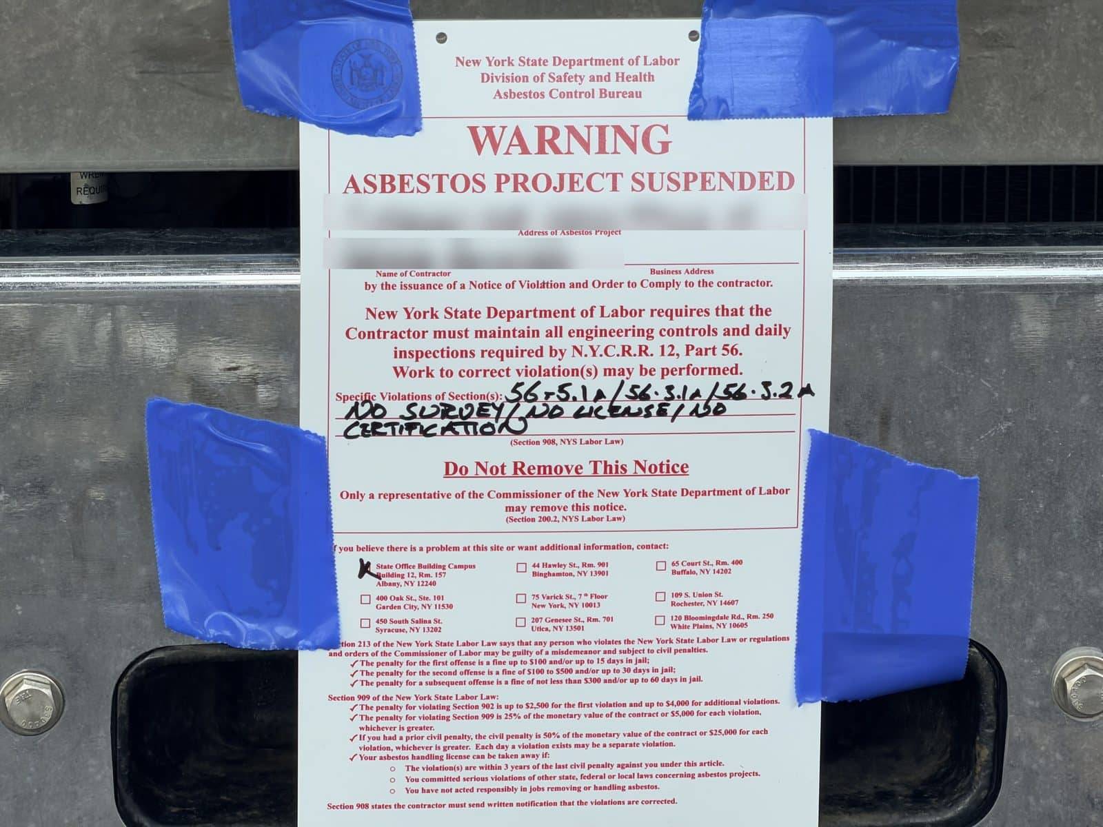 NYS DOL Asbestos Project Suspended notice posted at a job site
