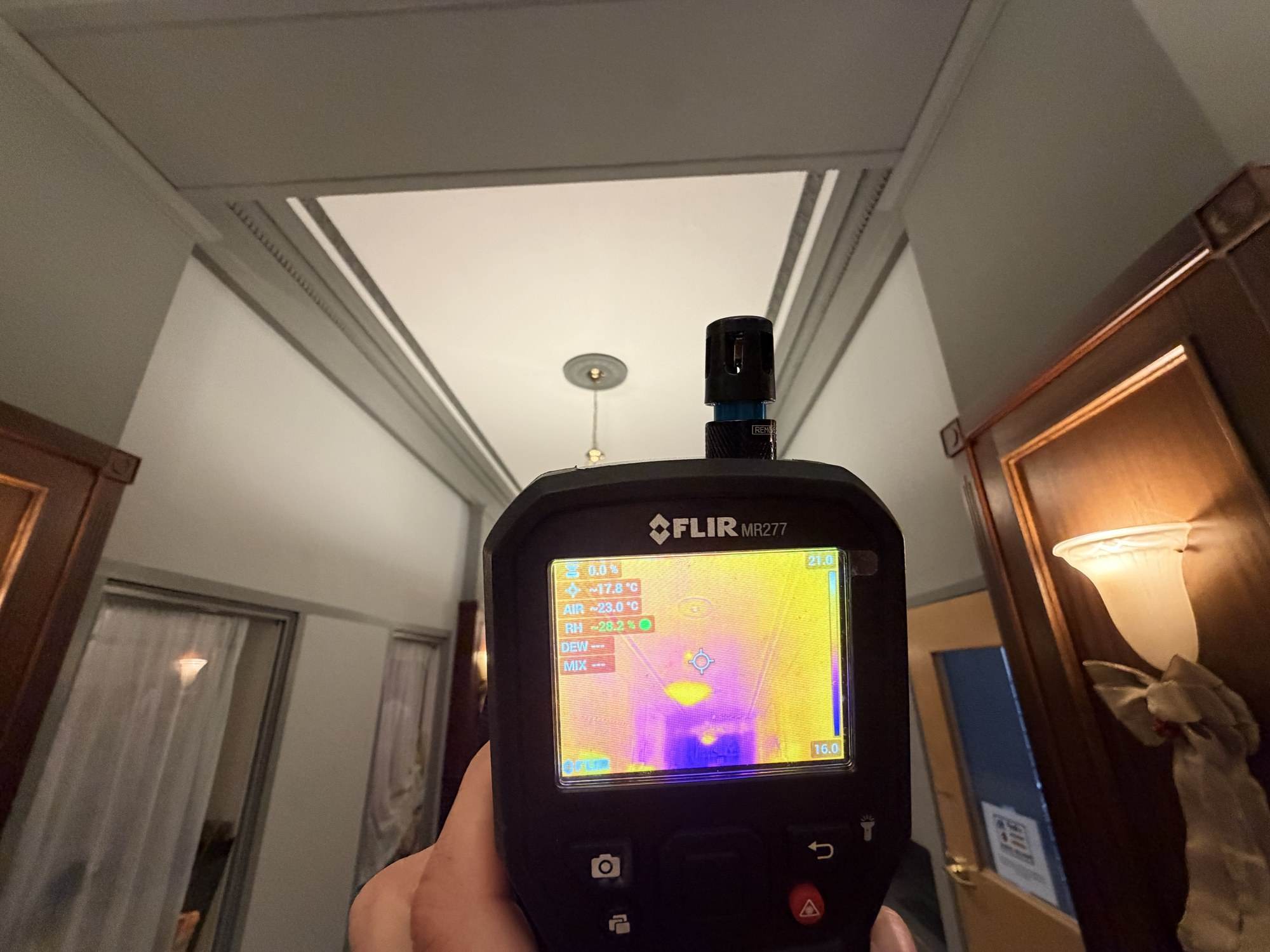Thermal camera view of a finished hallway ceiling during an on-site investigation